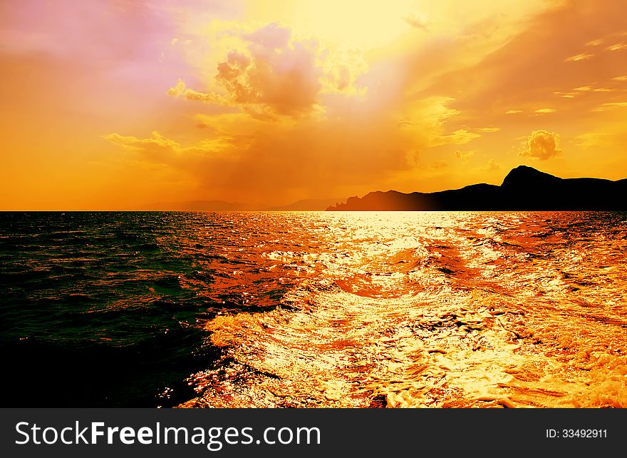 Beautiful view of Black Sea with dark mountains on horizon under clouds