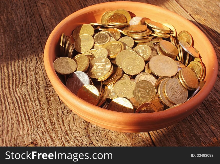 Coins on brown baclground of wooden
