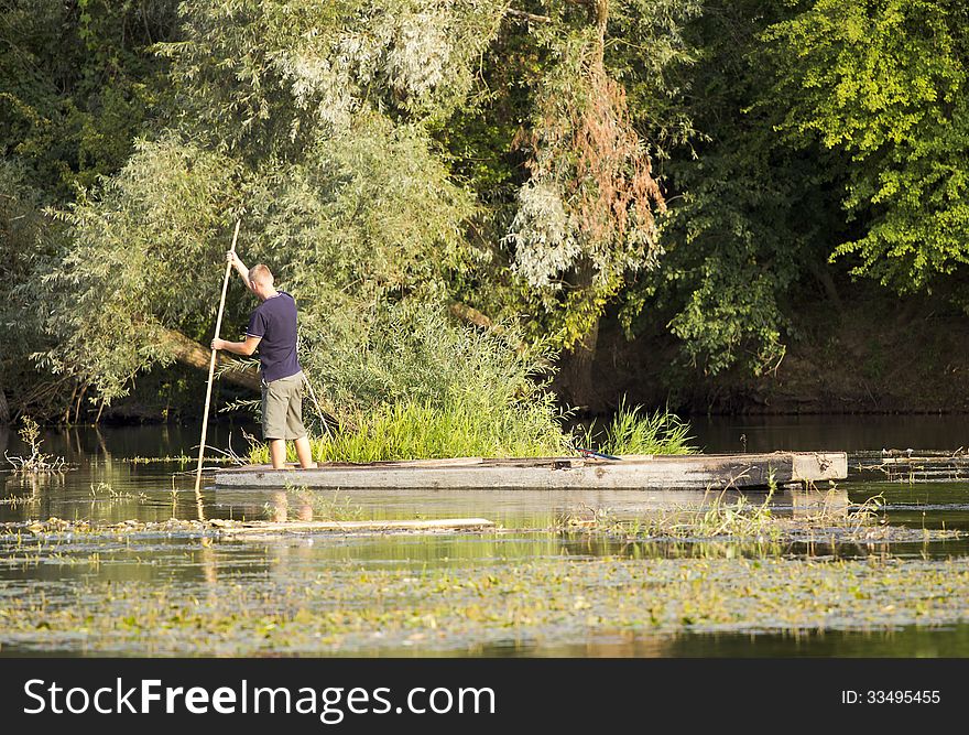 Life by the river. Man on the old wooden rowboat. Life by the river. Man on the old wooden rowboat.