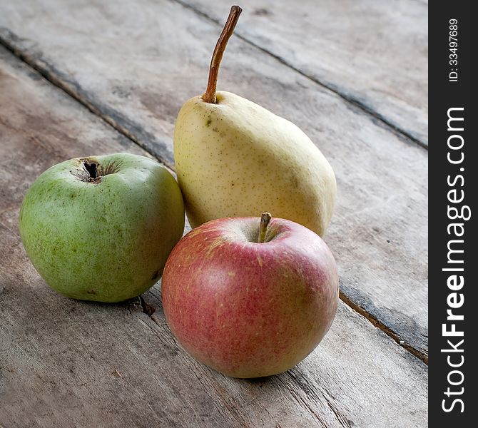 Fresh organic apples and pears on wooden table