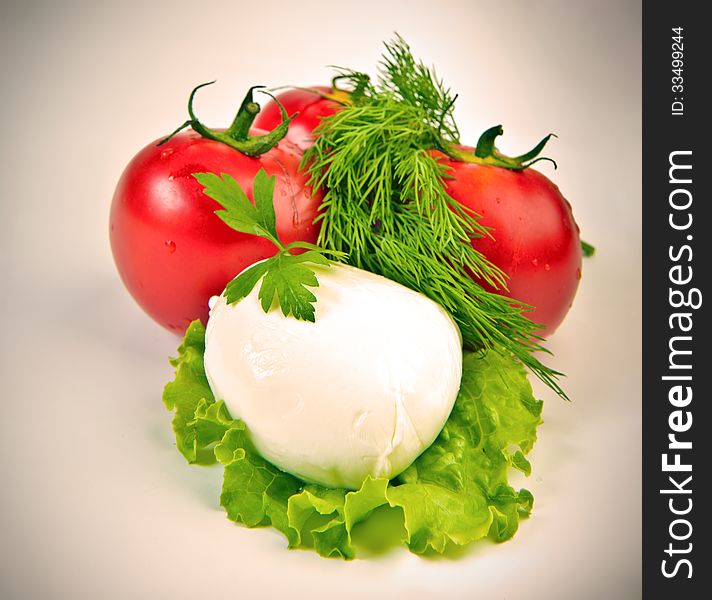 Mozzarella ball on lettuce leaf over vintage background