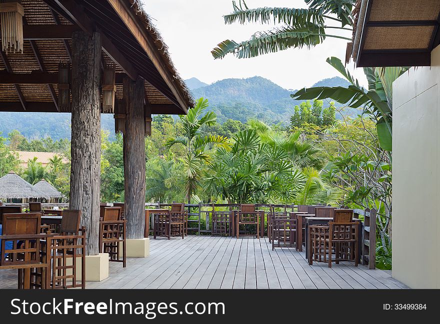 Open-air restaurant on a background of palm trees with garlands. Open-air restaurant on a background of palm trees with garlands.