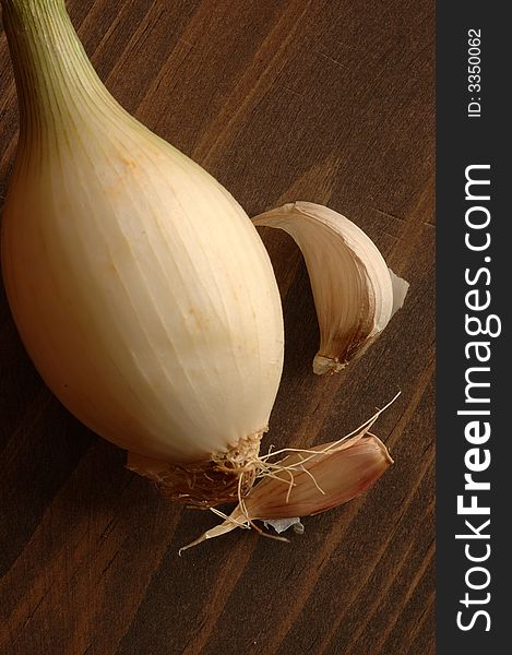 Onion and garlic in background of wood