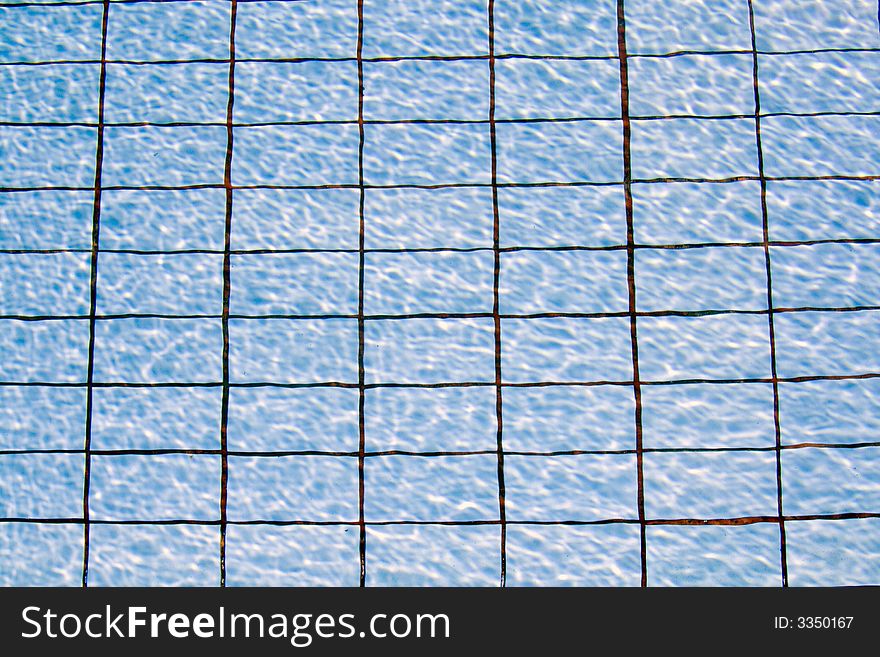 Swimming pool water background with the pattern of the tiles in the bottom showing. Swimming pool water background with the pattern of the tiles in the bottom showing.