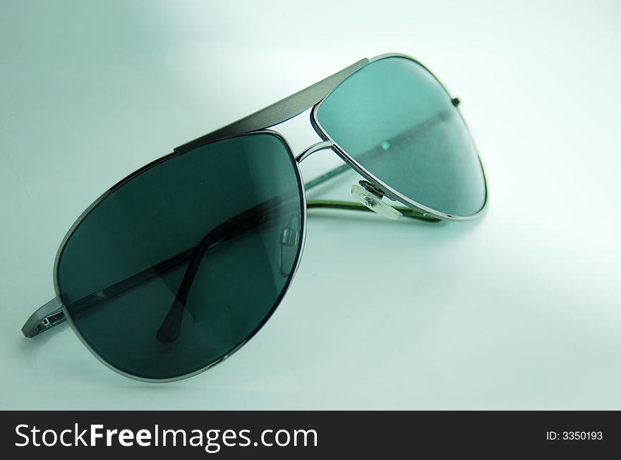 Modern fashionable summer sunglasses with green lenses