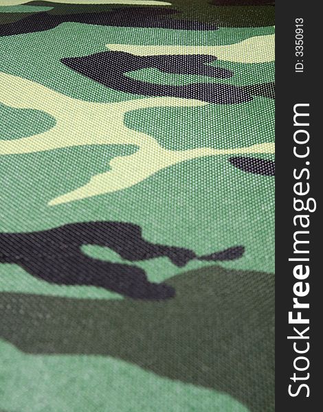 Green, black, grey, brown, yellow - abstract camouflage pattern selective focus