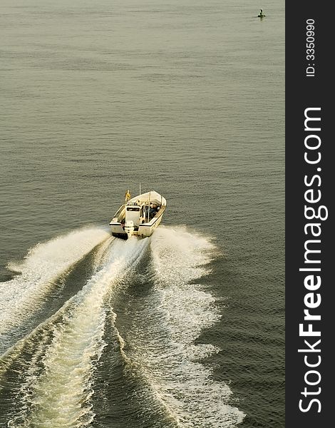 Fishing boat speeding out to sea