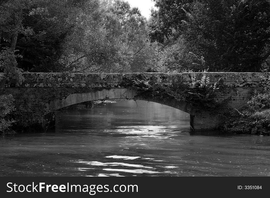 A small stone bridge on Saone river, France. A small stone bridge on Saone river, France