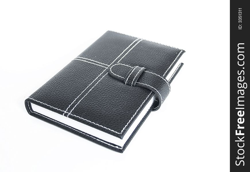 Black leather cased notebook, on white bacground with pen for writing. Black leather cased notebook, on white bacground with pen for writing.