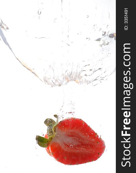 Photography of a strawberry splashing in water
