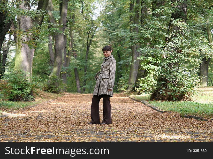 Beautiful woman walking in the autumn park. Beautiful woman walking in the autumn park