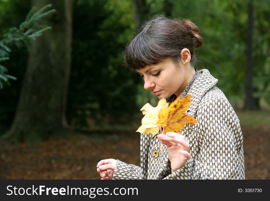 Beautiful woman walking in the autumn park. Beautiful woman walking in the autumn park