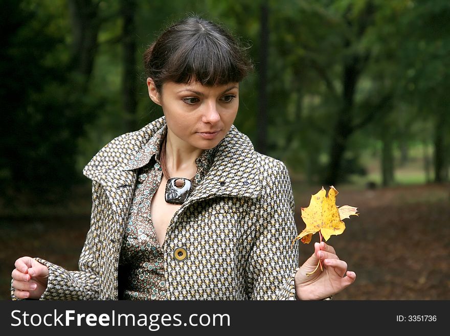 Beautiful woman walking in the autumn park. Beautiful woman walking in the autumn park