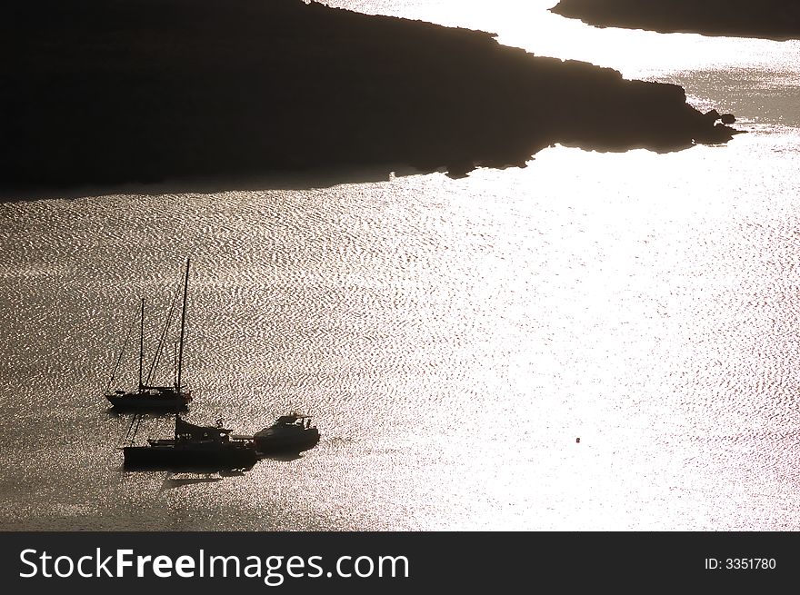 Sailing boats anchored in a harbour at sunrise. Sailing boats anchored in a harbour at sunrise