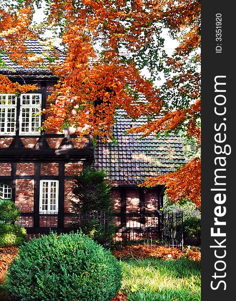 Half-timbered house with front-garden in autumn colors