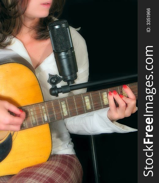 Young women performing guitar and voice. Young women performing guitar and voice