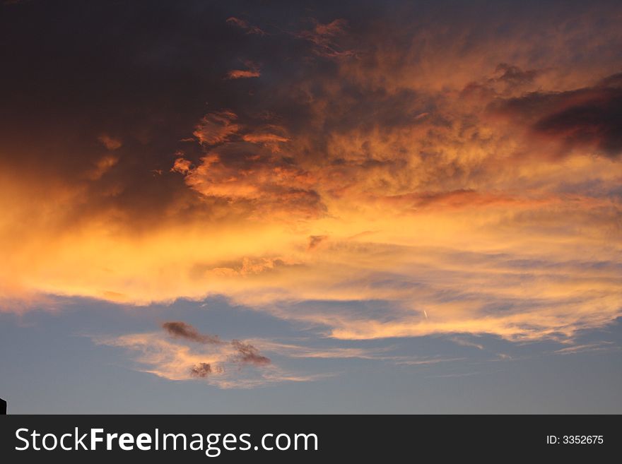 Western sunset with fire breathing lion in the right upper 1/3.  Also some seee a face wearing sunglasses with the lion being the forehead. Western sunset with fire breathing lion in the right upper 1/3.  Also some seee a face wearing sunglasses with the lion being the forehead.