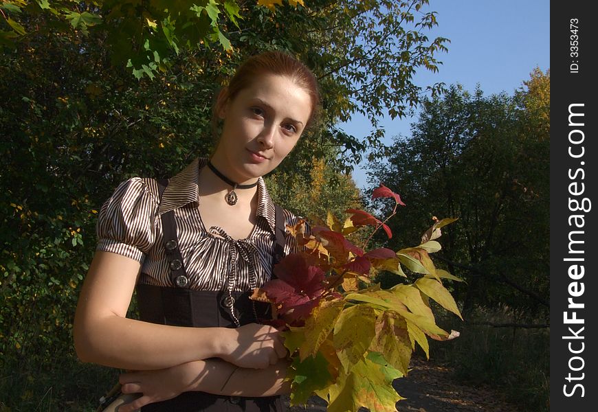 A girl with bouquet In autumn