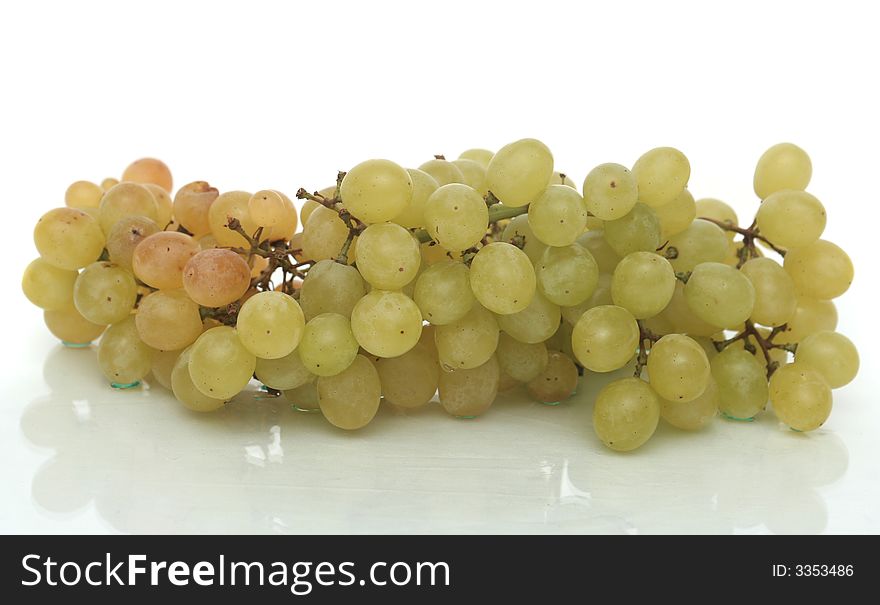 Cluster of green tasty grapes on a white background