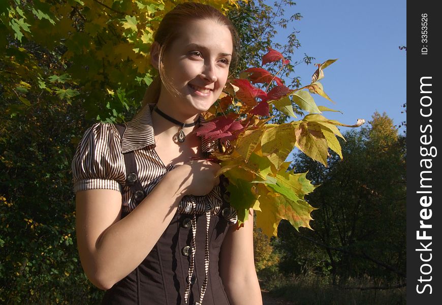 A girl with bouquet In autumn