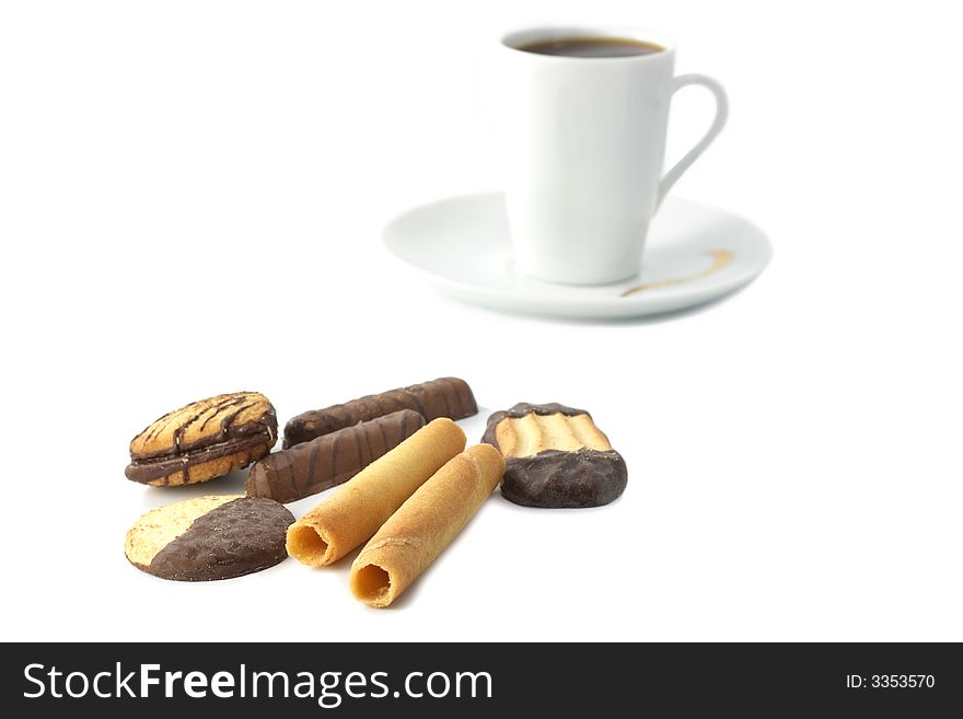 Cookies and biscuits isolated on white  with cup of coffee (tea) in not focus zone. Cookies and biscuits isolated on white  with cup of coffee (tea) in not focus zone