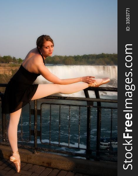 Teen ballerina with her leg resting on a railing overlooking Naigara Falls. Teen ballerina with her leg resting on a railing overlooking Naigara Falls.