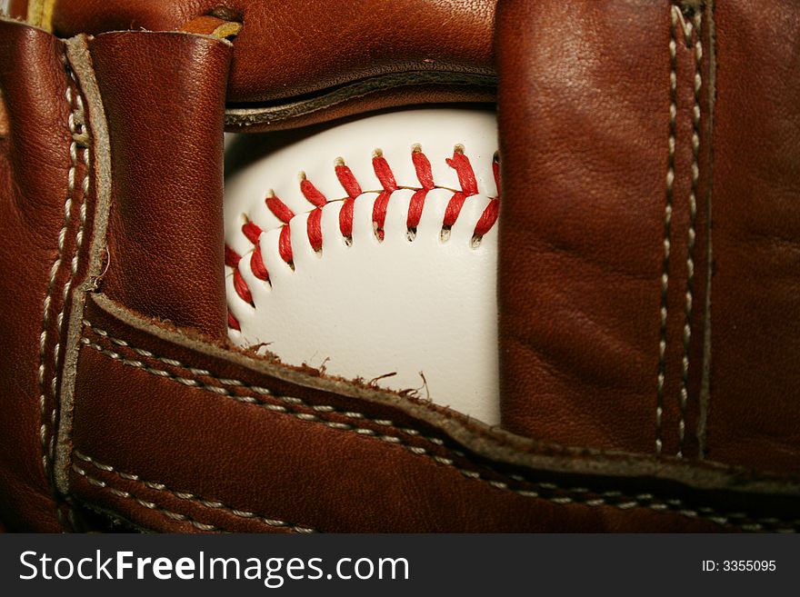 A close up of a Baseball in a glove