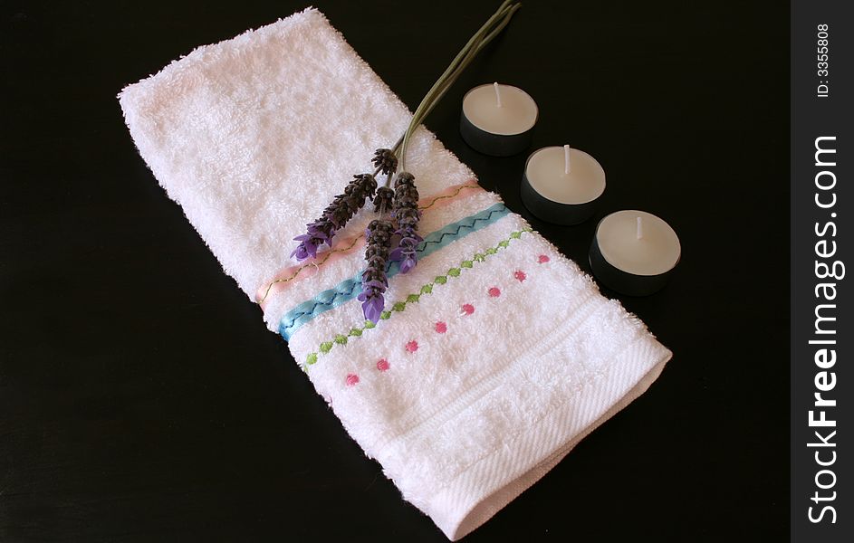 White face cloth with lavender and candles