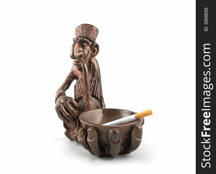 A figured ashtray executed in the form of the smoking person with a cigarette laying in it. A figured ashtray executed in the form of the smoking person with a cigarette laying in it