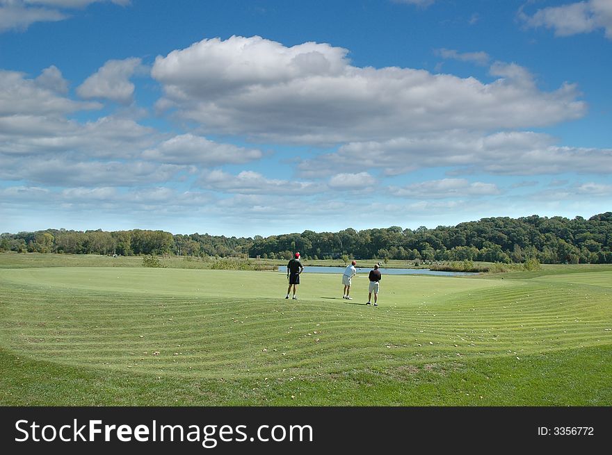 Group of golfers at the green on a sunny day