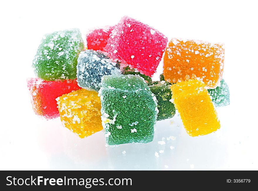 Delicious and colorful  jelly cubes on white background