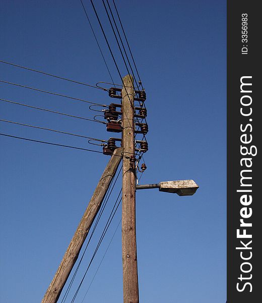 Old energy pole with a street lamp