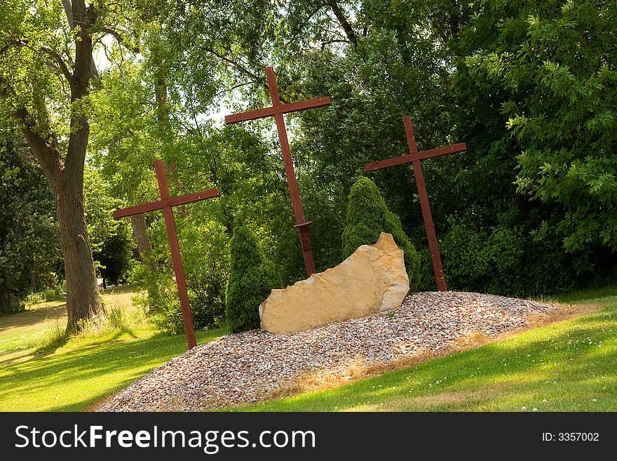 Three tall Christian crosses at a park memorial. Three tall Christian crosses at a park memorial.