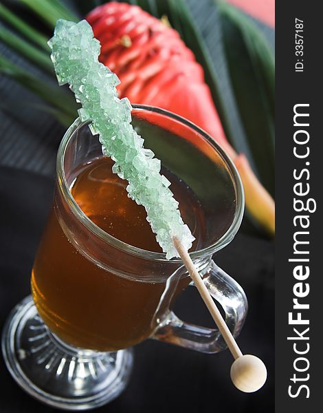 Cup of tea with rock candy stick
