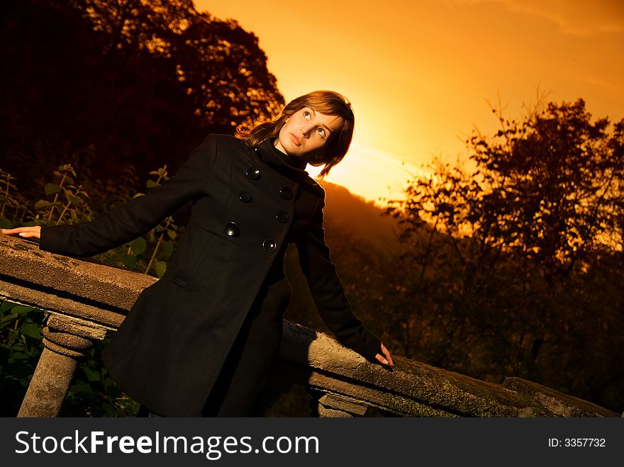 Beautiful thinking girl at sunset time