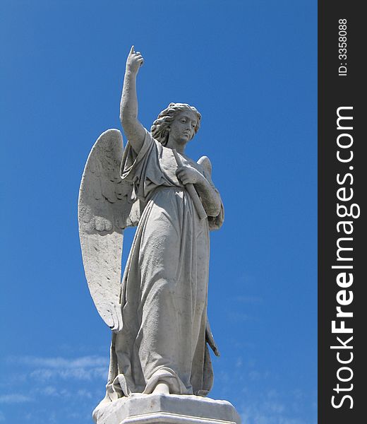 Detail of winged angel against blue sky. Detail of winged angel against blue sky