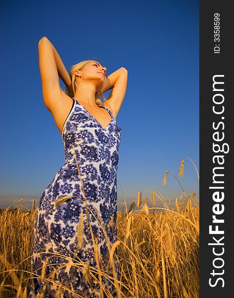 Beautiful blond girl relaxing in the field