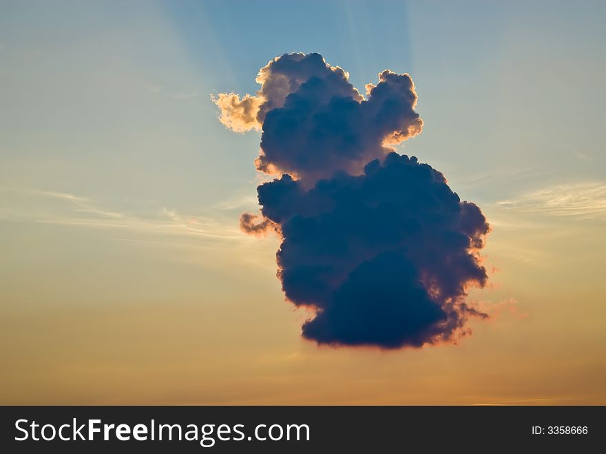 Cloud formation at sunset against a deep blue sky