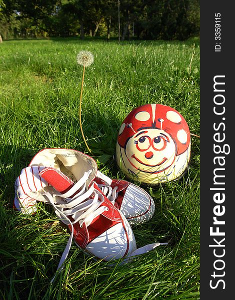 View of a pair of athletic shoes and helmet on grass