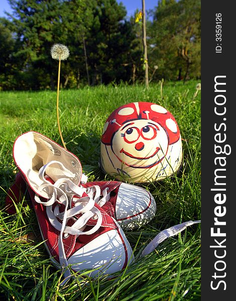 View of a pair of athletic shoes and helmet on grass