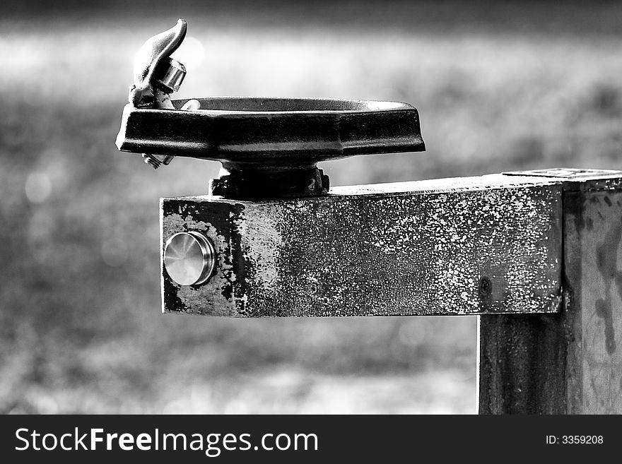 A weathered water fountain in black and white at Losco Park in Jacksonville Florida