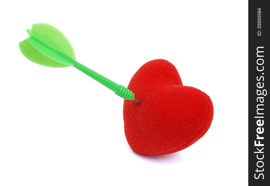 Red heart stabbed by green dart on white background. Red heart stabbed by green dart on white background