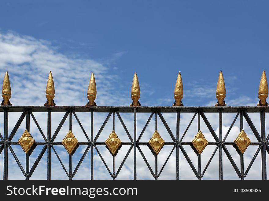 Top of steel fence with Thai art style on blue sky background. Top of steel fence with Thai art style on blue sky background