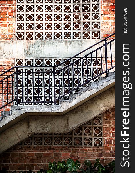 Outdoor staircase with a red brick wall