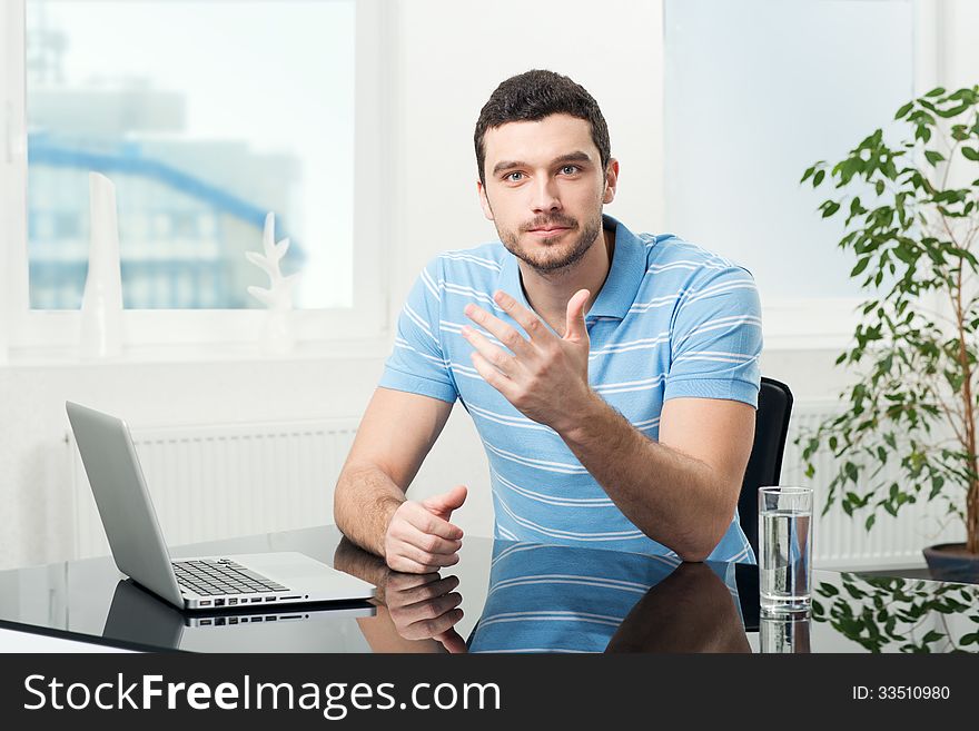 Businesswoman Sitting At Table With Laptop