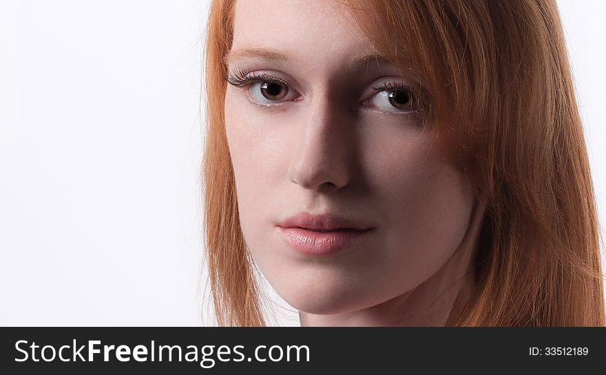 A close up portrait of a gorgeous young woman with red hair. A close up portrait of a gorgeous young woman with red hair
