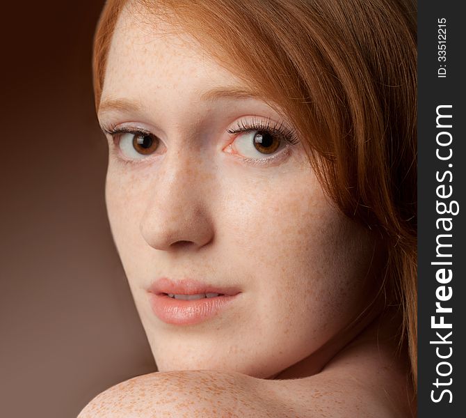A close up of a pretty young woman with freckles and red hair. A close up of a pretty young woman with freckles and red hair