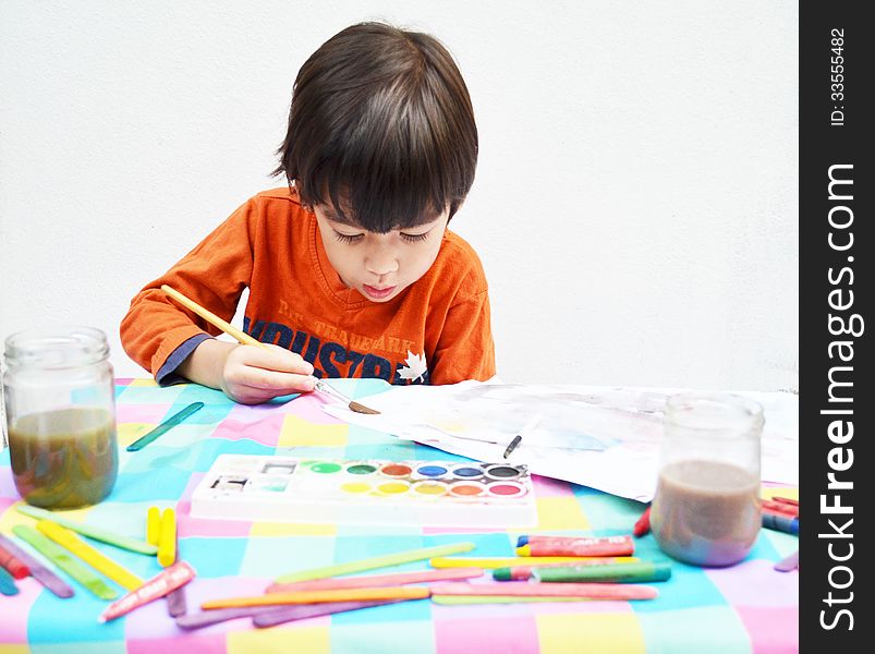 Little boy painting water color