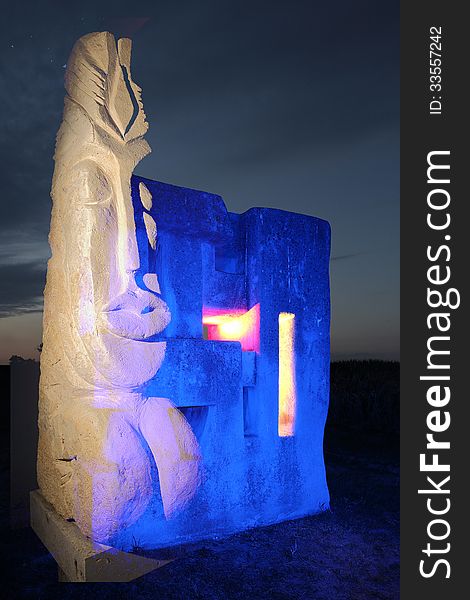 A composing of two stone sculptures, one realistic called Maya, the other one abstracted, called borderstone, this one was lit with blue light with colored openings. A composing of two stone sculptures, one realistic called Maya, the other one abstracted, called borderstone, this one was lit with blue light with colored openings