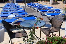 Sunny Outdoor Sunbeds And Patio Furniture Royalty Free Stock Photo